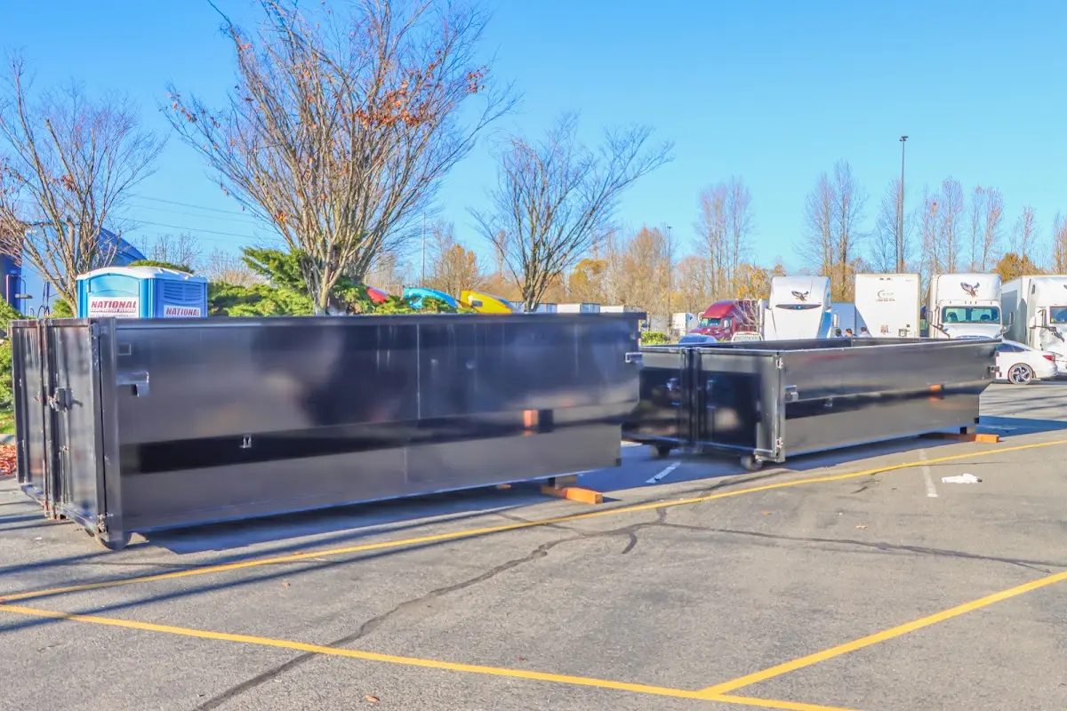 Professional dumpster rental service with roll-off container on residential driveway in Ocoee